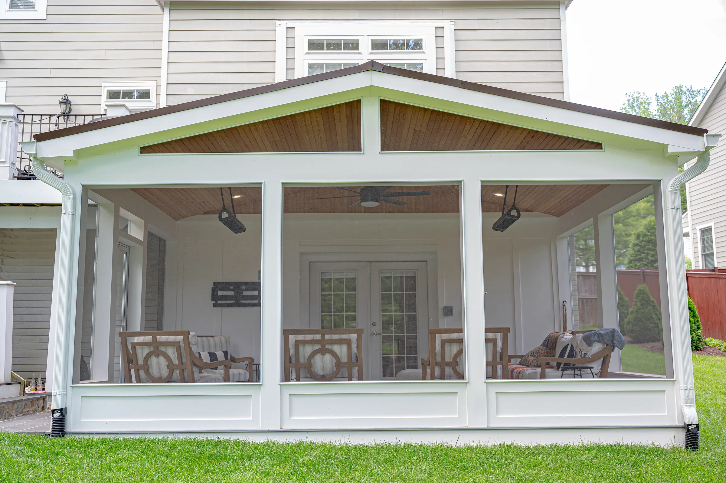 Front of the gabled screened porch with a stained wood gable, white knee walls and full-height screens